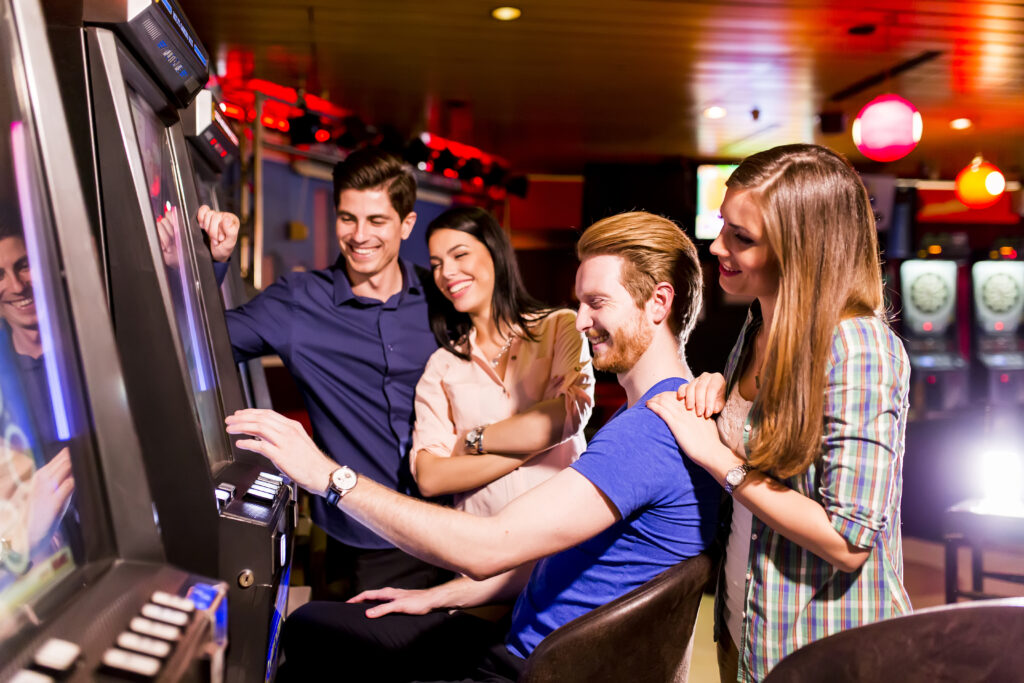 group-of-friends-playing-slot-machines-in-casino