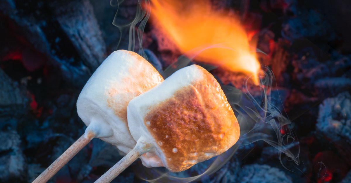 two marshmallows roasting together over a fire
