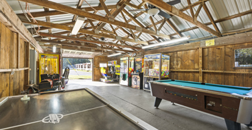 arcade and game room with foosball and pool table