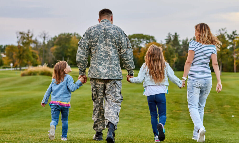 military family holds hands