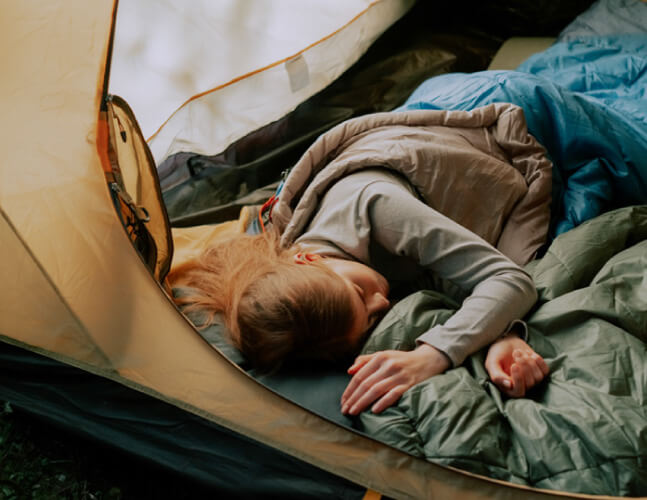 girl sleeping in tent