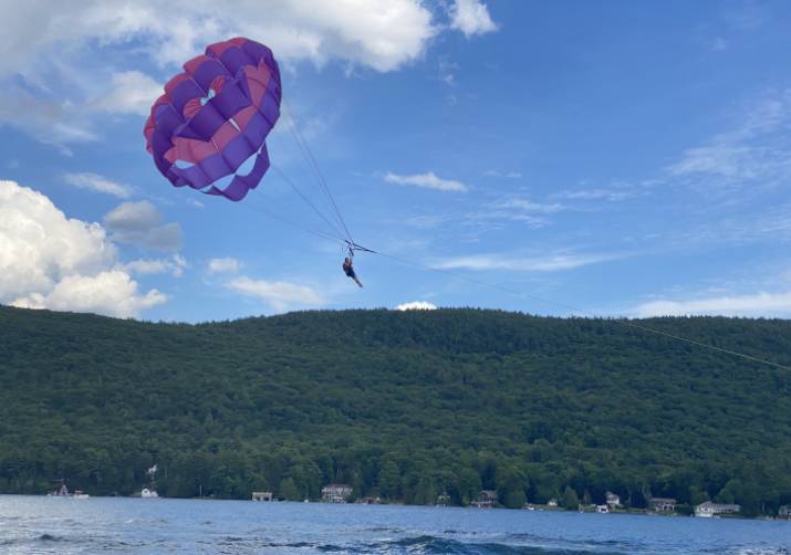 person parasails over a lake