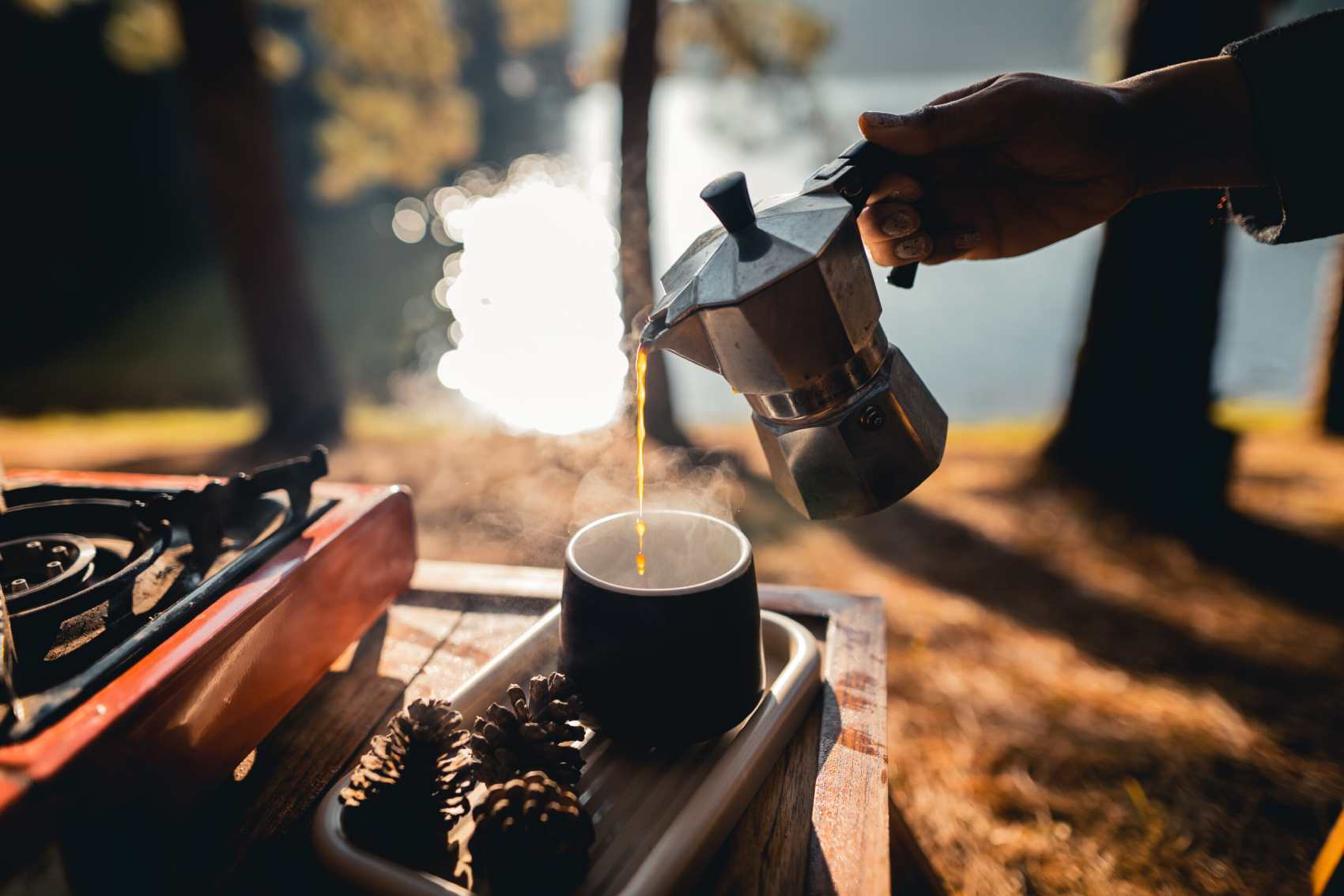 pouring-coffee-outside-camping