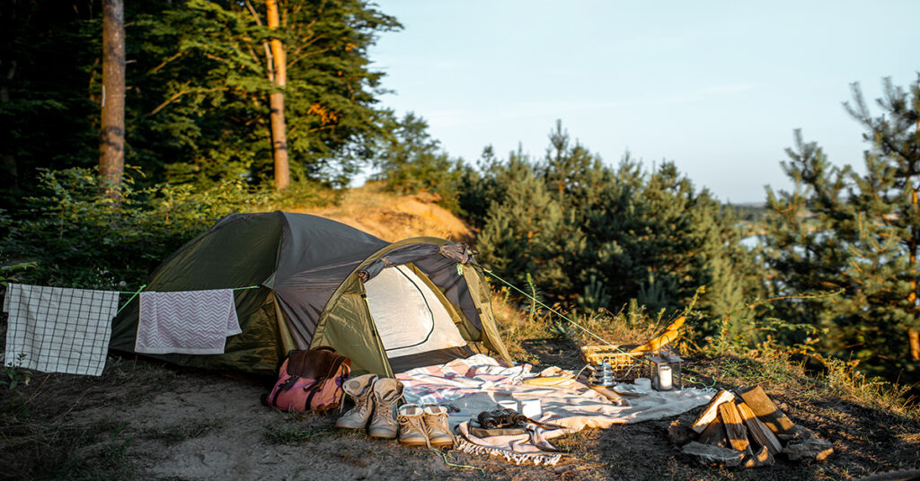 camping tent with supplies laid out outside it