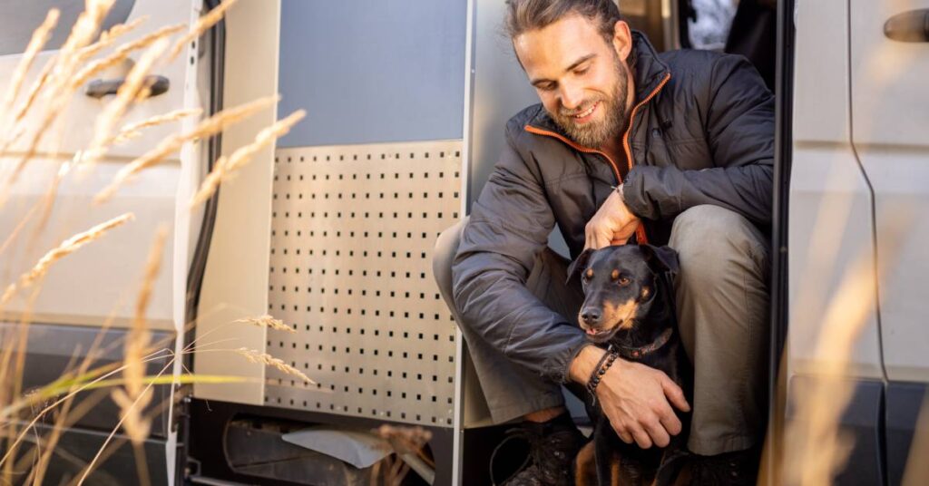 man with dog on rv steps