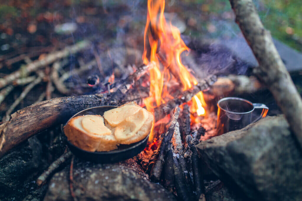 food on pan over campfire