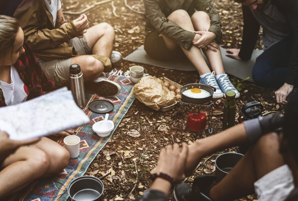 group-of-friends-camping-eating-together