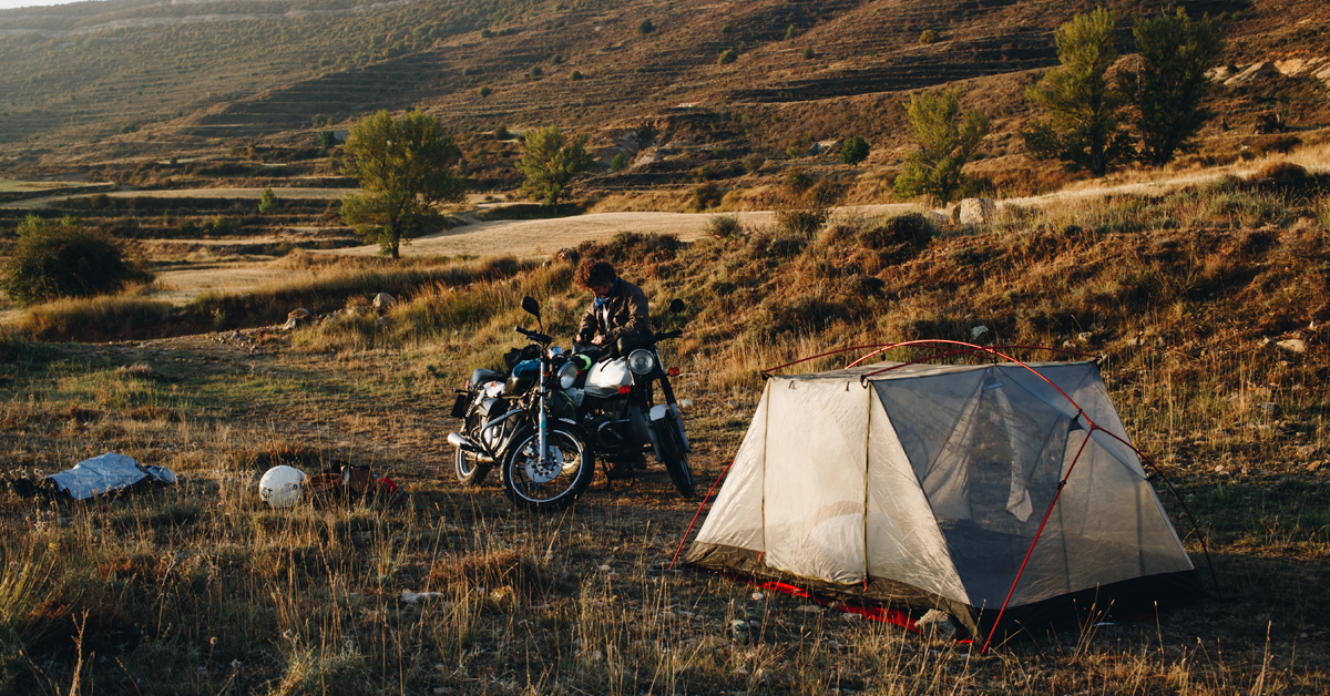 motorcyclist-camping-in-the-wild-tent-setup