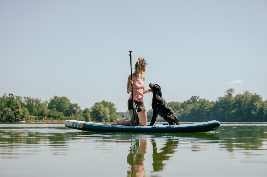 woman-on-sup-with-her-dog-in-a-lake
