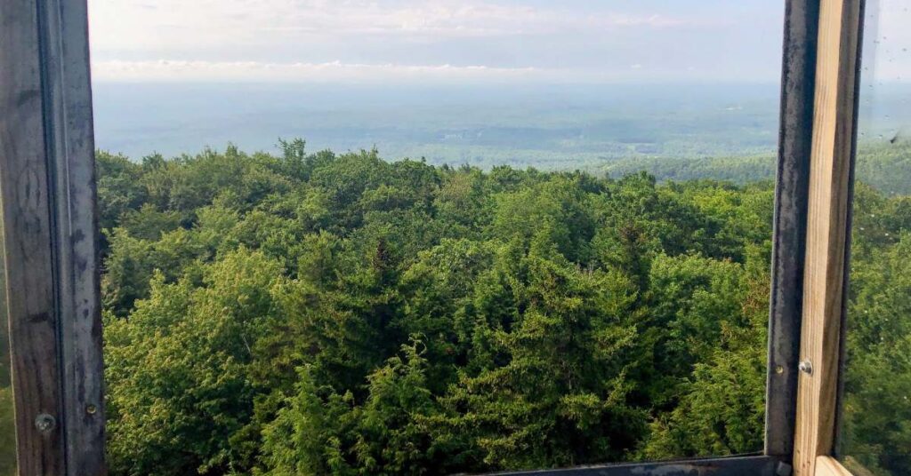 view looking out from fire tower at surrounding mountains