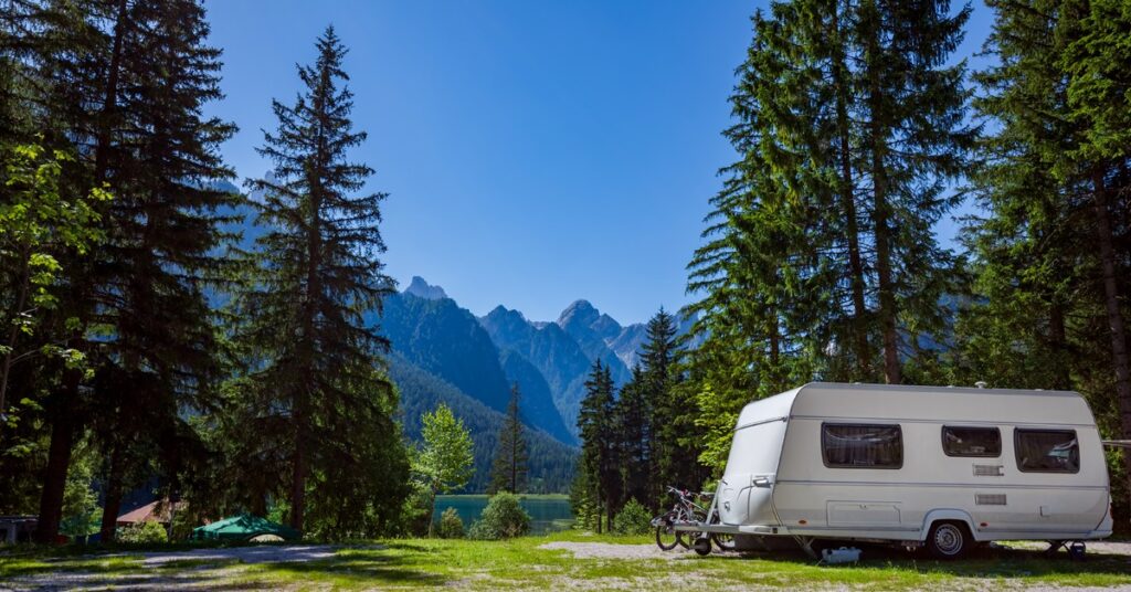 RV with mountains and tent sites in the background