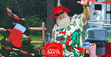 Santa waving at Christmas in July party