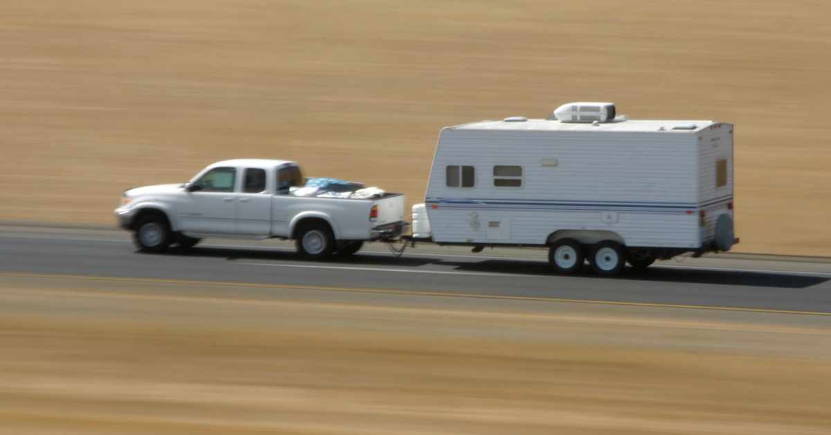 truck towing an rv camper on a road