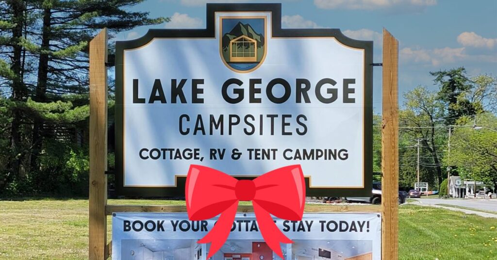 lake george campsites sign with a red bow